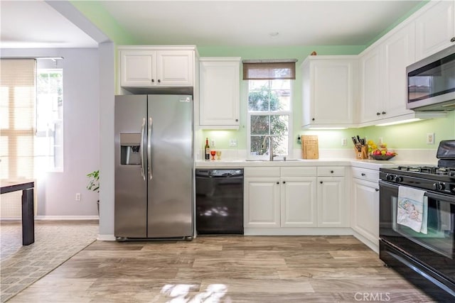 80 Great Lawn, Irvine, CA 92620 - kitchen featuring black appliances, a sink, and white cabinets