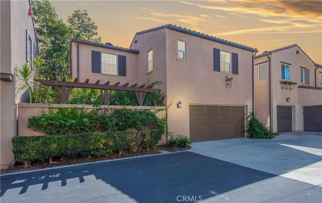 80 Great Lawn, Irvine, CA 92620 - view of front facade with stucco siding, a garage, a tile roof, and concrete driveway