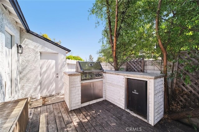 18356 Friar St, Tarzana, CA 91335 - wooden terrace with an outdoor kitchen, grilling area, and a fenced backyard