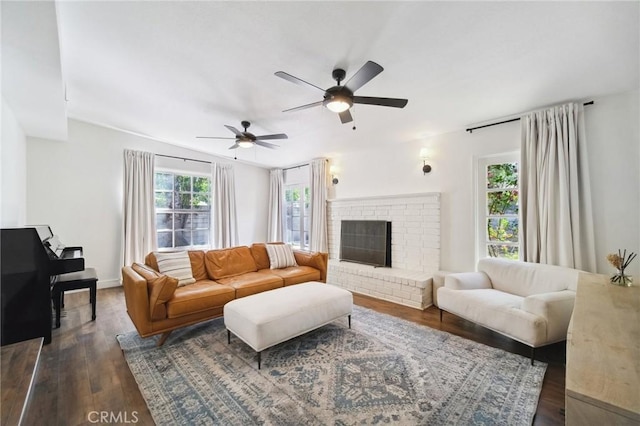18356 Friar St, Tarzana, CA 91335 - living room with dark wood-style flooring, ceiling fan, and a fireplace