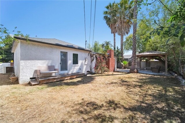 18356 Friar St, Tarzana, CA 91335 - rear view of house featuring a gazebo, stucco siding, central air condition unit, and a patio area