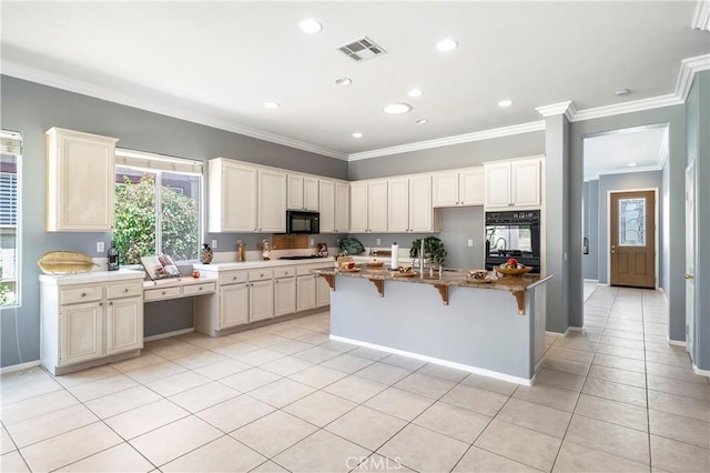 29365 Sparkling Dr, Menifee, CA 92584 - kitchen featuring black microwave, light tile patterned floors, crown molding, a kitchen bar, and recessed lighting