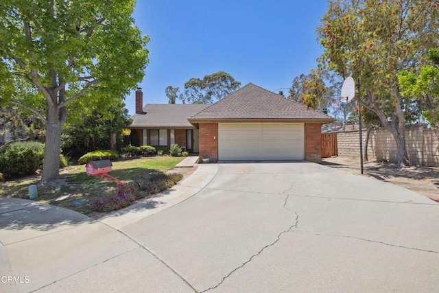 1093 Hickory View Cir, Camarillo, CA 93012 - view of front of house with an attached garage, concrete driveway, a chimney, and brick siding