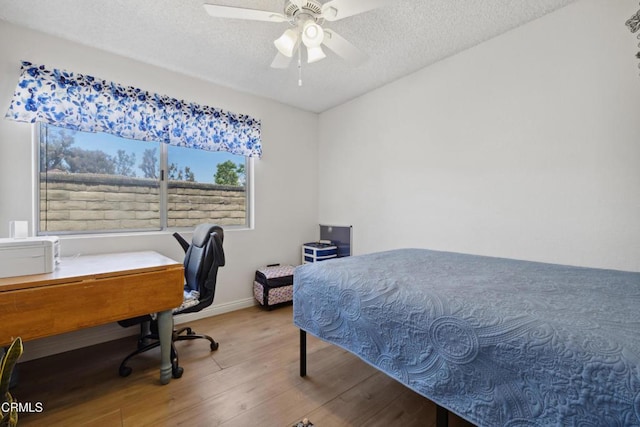 1093 Hickory View Cir, Camarillo, CA 93012 - bedroom featuring wood finished floors, an office area, a textured ceiling, baseboards, and ceiling fan