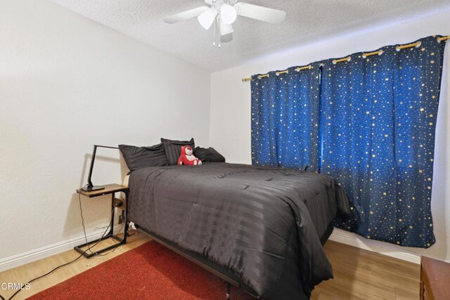 1093 Hickory View Cir, Camarillo, CA 93012 - bedroom featuring wood finished floors, baseboards, a textured ceiling, and a ceiling fan