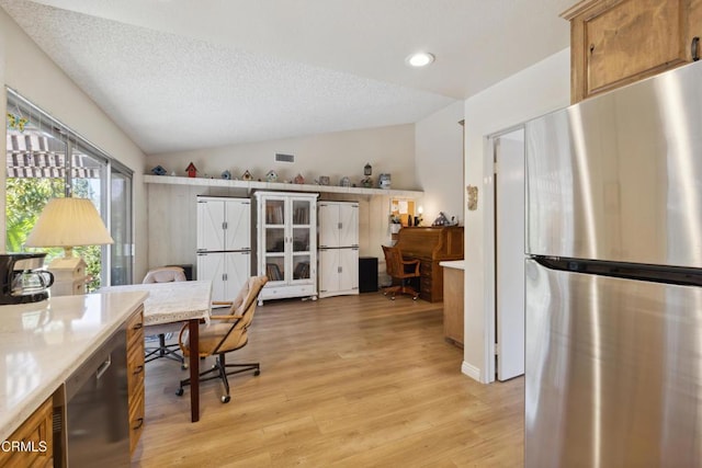 1093 Hickory View Cir, Camarillo, CA 93012 - kitchen featuring appliances with stainless steel finishes, a desk, vaulted ceiling, light countertops, and brown cabinets