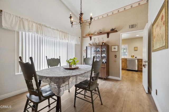 1093 Hickory View Cir, Camarillo, CA 93012 - dining area with a chandelier, baseboards, light wood finished floors, and high vaulted ceiling