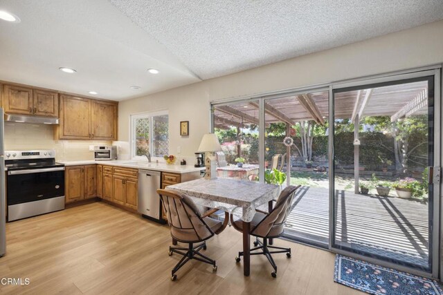 1093 Hickory View Cir, Camarillo, CA 93012 - kitchen with appliances with stainless steel finishes, under cabinet range hood, light wood-style flooring, decorative backsplash, and recessed lighting