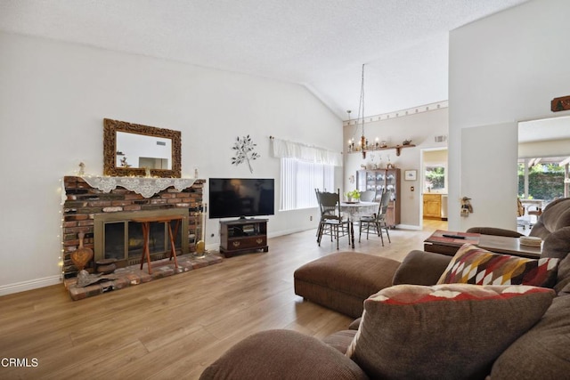 1093 Hickory View Cir, Camarillo, CA 93012 - living area with a chandelier, high vaulted ceiling, wood finished floors, baseboards, and a fireplace