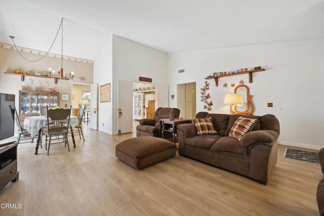 1093 Hickory View Cir, Camarillo, CA 93012 - living area featuring high vaulted ceiling, a chandelier, light wood-style flooring, and baseboards