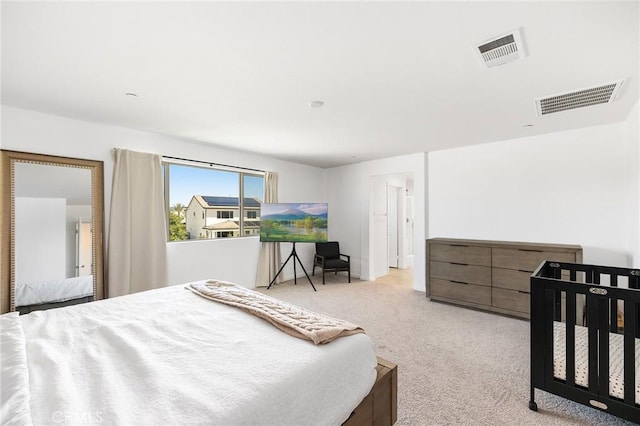 bedroom featuring light carpet