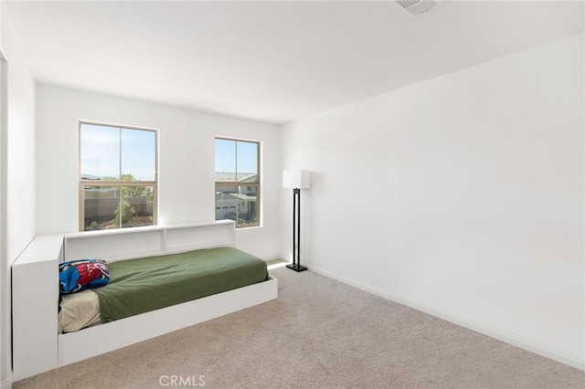 carpeted bedroom with baseboards