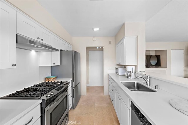 21703 Ocean Vista Dr Unit 102, Laguna Beach, CA 92651 - kitchen with under cabinet range hood, appliances with stainless steel finishes, a sink, light countertops, and white cabinets