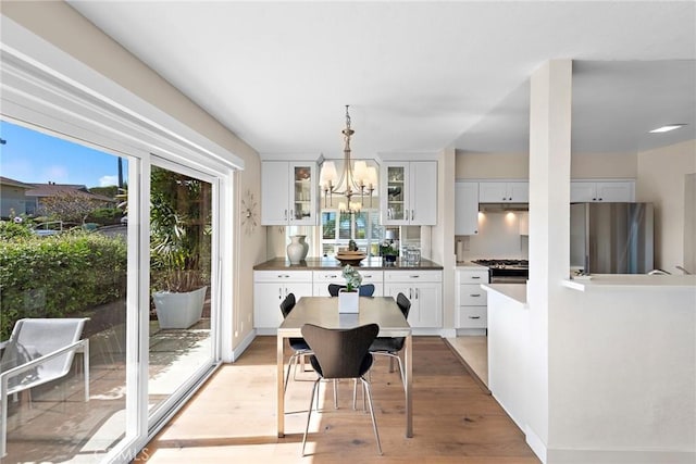 21703 Ocean Vista Dr Unit 102, Laguna Beach, CA 92651 - dining area with light wood-type flooring and a chandelier