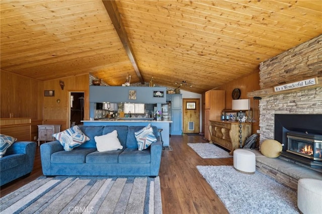 1179 Ridge Rd, Fawnskin, CA 92333 - living room featuring dark wood-type flooring, wood ceiling, a stone fireplace, and wooden walls