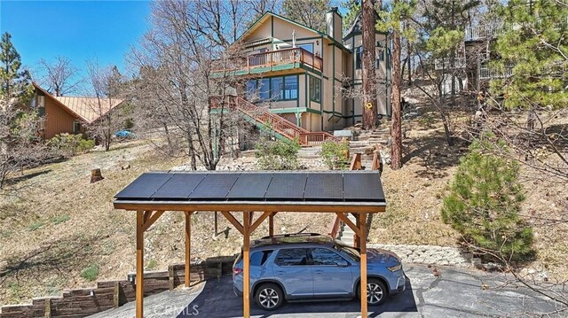 1179 Ridge Rd, Fawnskin, CA 92333 - view of vehicle parking featuring stairs and a carport