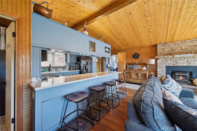 1179 Ridge Rd, Fawnskin, CA 92333 - kitchen featuring open floor plan, refrigerator with ice dispenser, wood finished floors, a kitchen bar, and wood ceiling