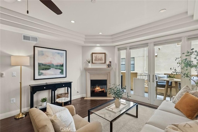 12044 Hoffman St Unit 204, Studio City, CA 91604 - living room featuring a ceiling fan, baseboards, wood finished floors, a raised ceiling, and a glass covered fireplace