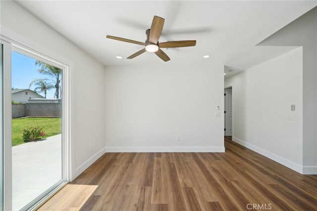 spare room with baseboards, a ceiling fan, wood finished floors, and recessed lighting