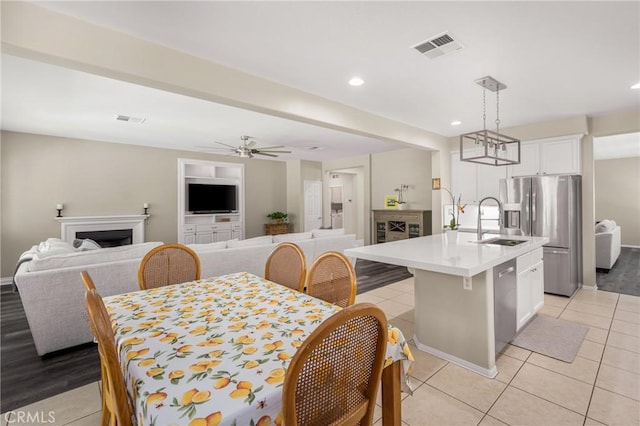 32748 Stonefield Ln, Temecula, CA 92592 - dining room with a fireplace, light tile patterned flooring, recessed lighting, a ceiling fan, and baseboards