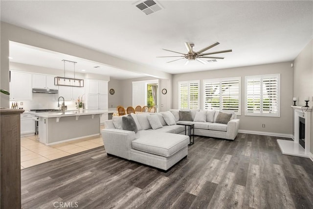 32748 Stonefield Ln, Temecula, CA 92592 - living area with a ceiling fan, wood finished floors, and baseboards