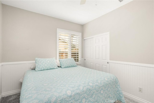 32748 Stonefield Ln, Temecula, CA 92592 - bedroom with carpet flooring, a wainscoted wall, baseboards, a closet, and a ceiling fan