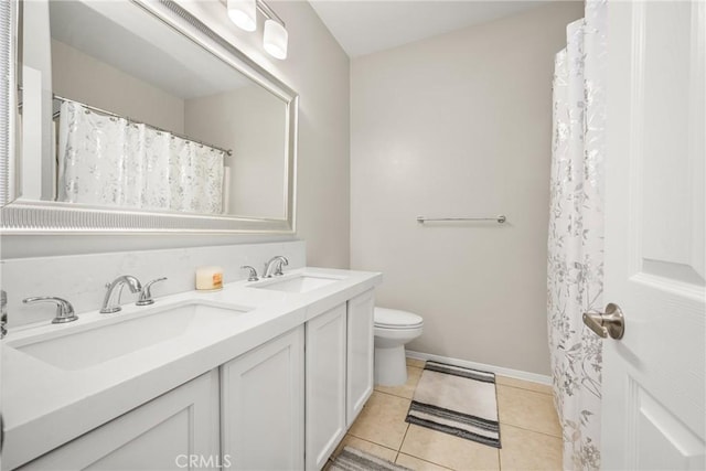 32748 Stonefield Ln, Temecula, CA 92592 - bathroom featuring tile patterned floors, toilet, double vanity, and baseboards