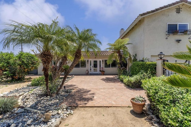 8534 Beverly Dr, San Gabriel, CA 91775 - back of house with french doors, stucco siding, a patio area, a tiled roof, and a chimney