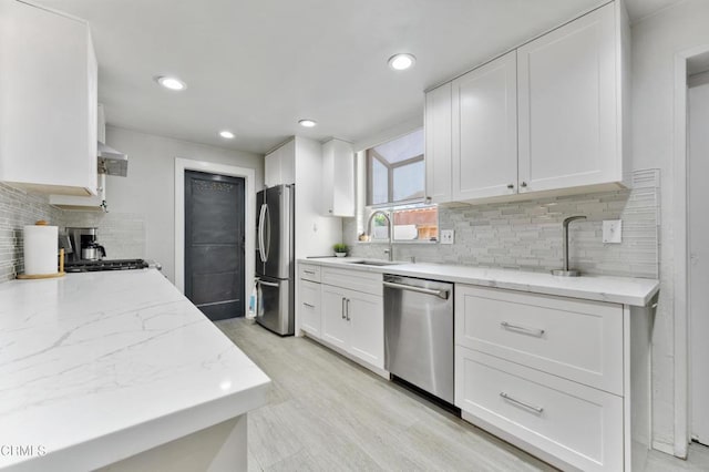 8534 Beverly Dr, San Gabriel, CA 91775 - kitchen featuring stainless steel appliances, white cabinetry, tasteful backsplash, light stone countertops, and recessed lighting