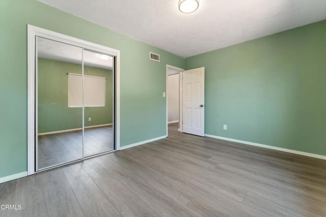 8534 Beverly Dr, San Gabriel, CA 91775 - unfurnished bedroom with wood finished floors, a closet, and a textured ceiling