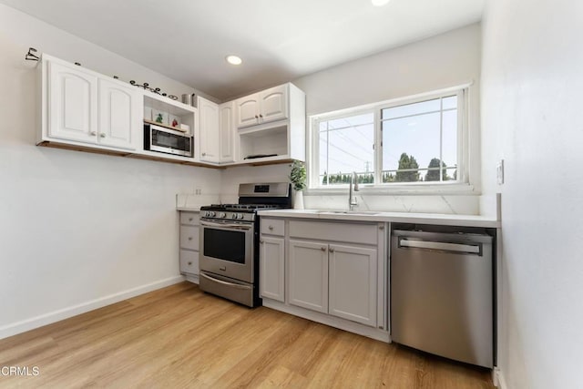 8534 Beverly Dr, San Gabriel, CA 91775 - kitchen with stainless steel appliances, open shelves, light wood-style flooring, light countertops, and recessed lighting