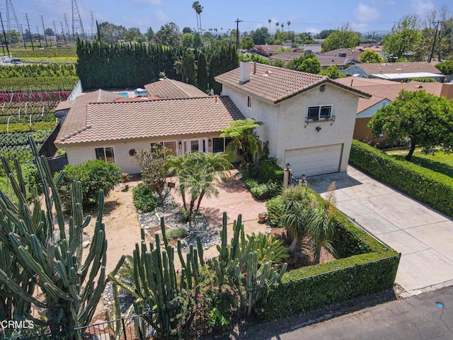 8534 Beverly Dr, San Gabriel, CA 91775 - mediterranean / spanish house featuring stucco siding, a garage, concrete driveway, and a tile roof