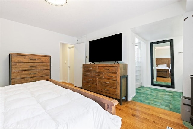 bedroom with wood finished floors