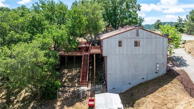 view of front of house featuring crawl space, stairs, and a wooden deck