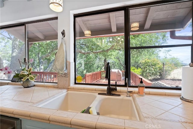 kitchen view of tile countertops and a sink