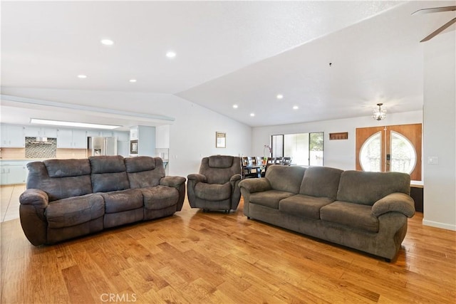 living area featuring vaulted ceiling, light wood-style flooring, a ceiling fan, and recessed lighting