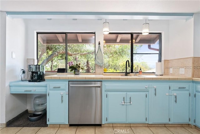 kitchen with stainless steel dishwasher, blue cabinets, decorative backsplash, a sink, and light tile patterned floors
