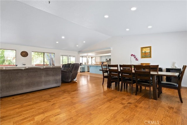 dining area with light wood finished floors, vaulted ceiling, and recessed lighting