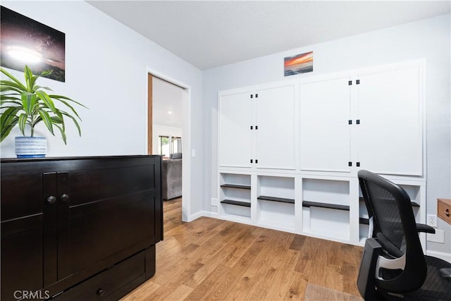home office featuring light wood finished floors and baseboards