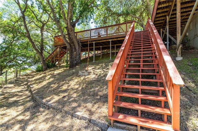 view of play area with stairway and a wooden deck