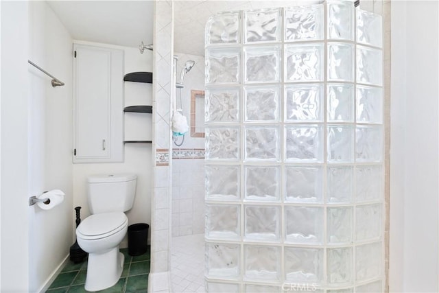 full bathroom featuring walk in shower, tile patterned floors, and toilet