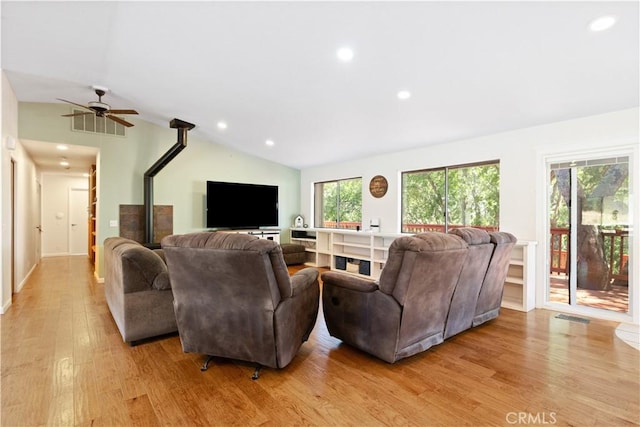 living room featuring vaulted ceiling, light wood finished floors, recessed lighting, and ceiling fan