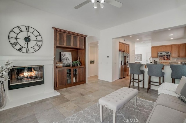 53 Via Palacio, San Clemente, CA 92673 - living room featuring a ceiling fan, a glass covered fireplace, recessed lighting, and arched walkways
