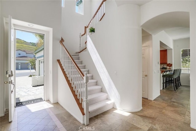 53 Via Palacio, San Clemente, CA 92673 - stairway with plenty of natural light, arched walkways, a high ceiling, and baseboards