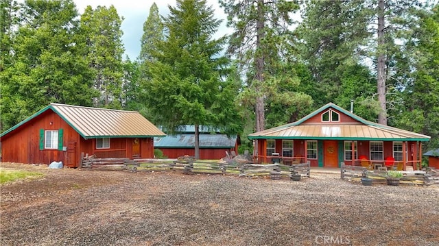 7072 Cranes Nest Rd, Mariposa, CA 95338 - chalet / cabin with covered porch, metal roof, and view of scattered trees