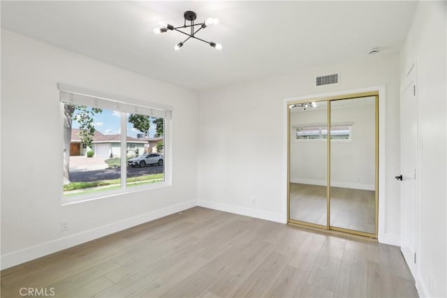 8064 Crosnoe Ave, Panorama City, CA 91402 - unfurnished bedroom featuring a chandelier, light wood-style floors, a closet, and baseboards