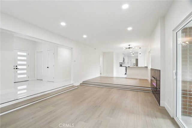 8064 Crosnoe Ave, Panorama City, CA 91402 - unfurnished living room featuring light wood-type flooring, recessed lighting, baseboards, and a chandelier