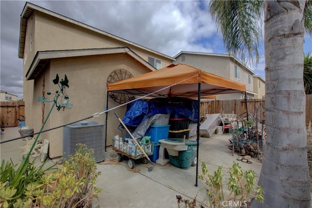 4374 Briggs Ln, Merced, CA 95348 - view of home's exterior featuring central AC unit, stucco siding, fence, and a patio