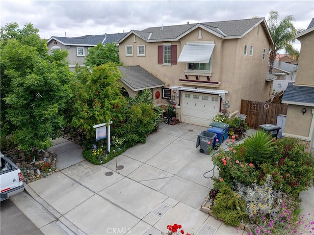 4374 Briggs Ln, Merced, CA 95348 - view of front of home featuring stucco siding, fence, concrete driveway, and a garage