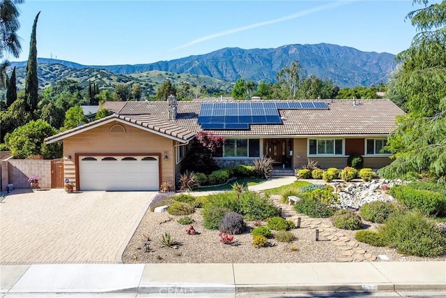 161 W Loretto Ct, Claremont, CA 91711 - ranch-style house with a tiled roof, a chimney, a mountain view, and a garage